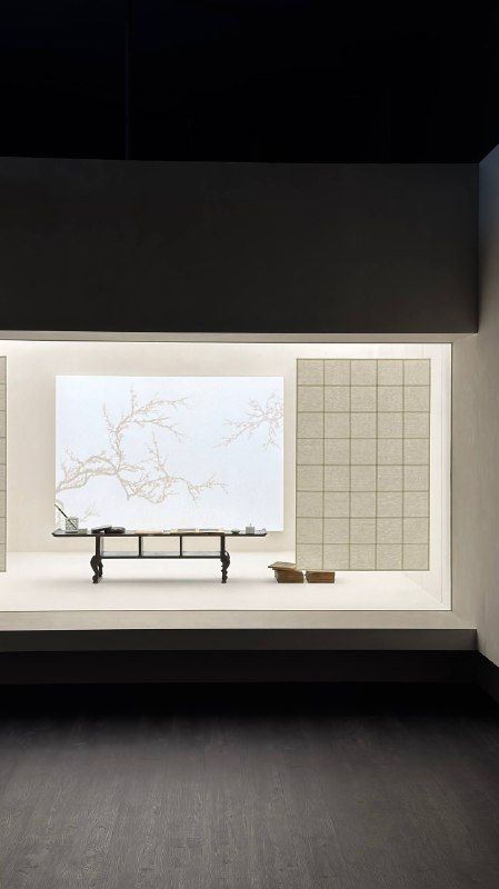 A small model of a pavilion displayed in a dark gallery case