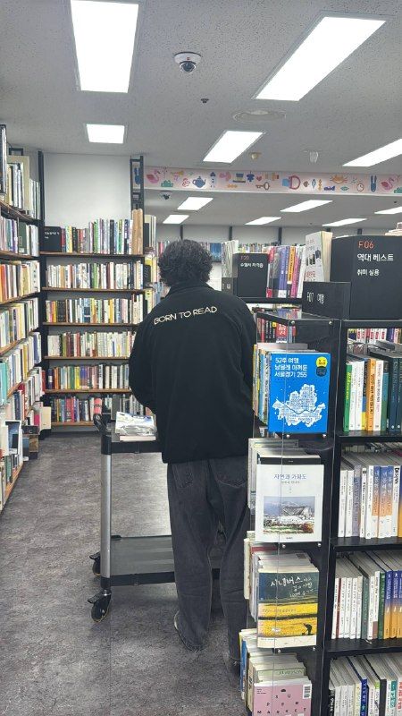 A man browsing shelves in a bright bookstore